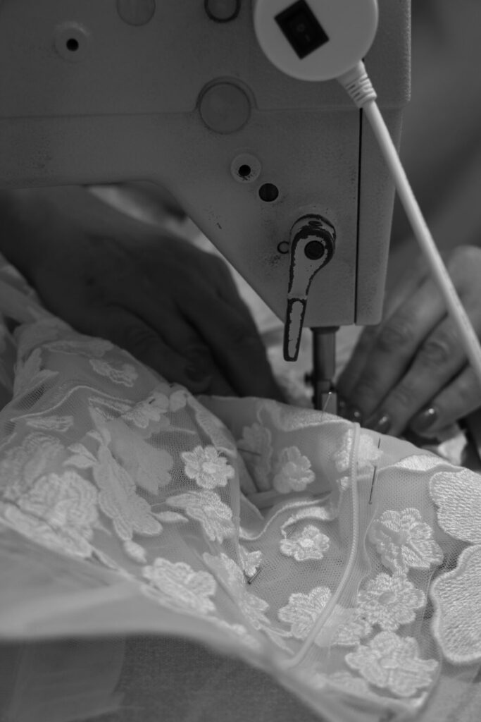Mira Zwillinger atelier: sewing hand-embroidered lace for the Alma wedding dress
