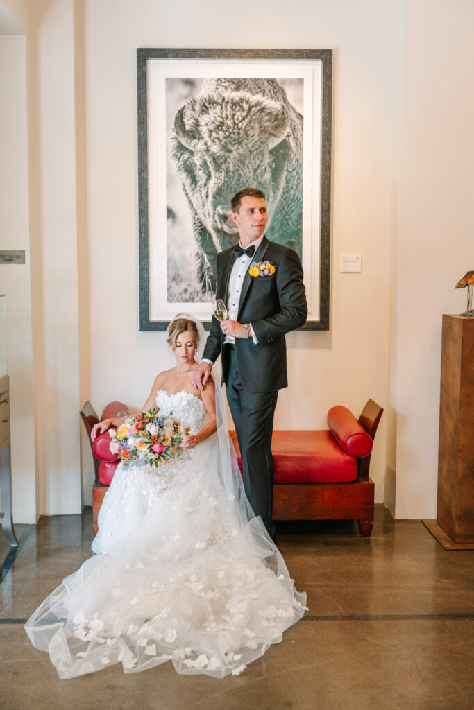 Elegant bride and groom pose with luxe décor.