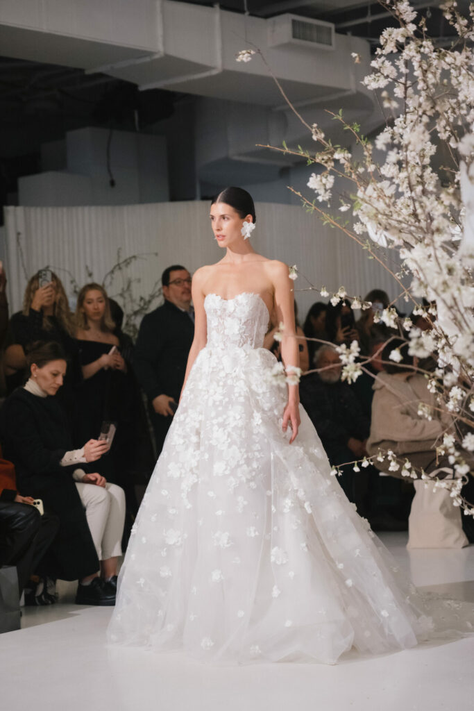 Model wearing the strapless Alma A-line wedding dress by Mira Zwillinger on the runway