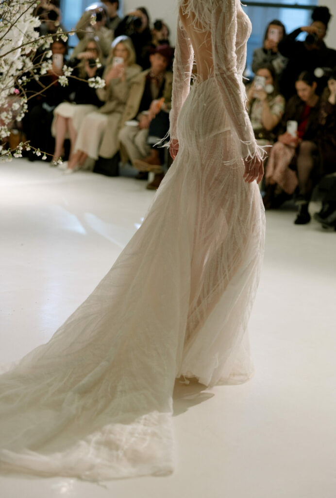 Model wearing the sheer Anouka gown by Mira Zwillinger on the runway