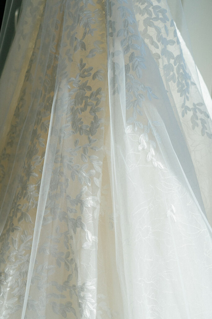 Sheer white lace fabric with elegant, soft texture.