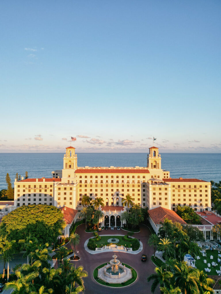 Twin-towered hotel, ocean view, sunset luxury backdrop.