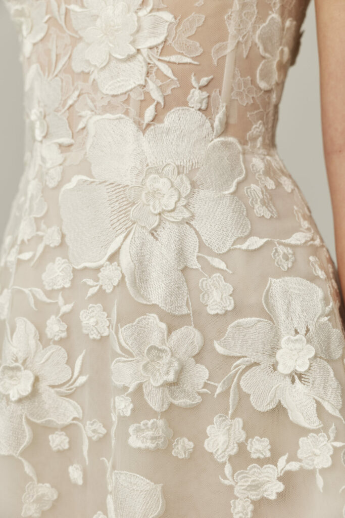 Detail of the Alma wedding dress by Mira Zwillinger with sheer floral lace embroidery
