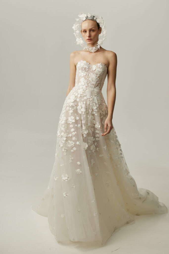Bride in the strapless Alma wedding dress by Mira Zwillinger with a floral headpiece