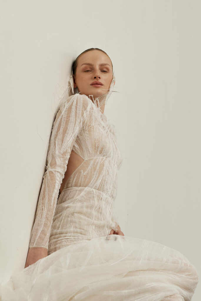 Close-up of the sheer long-sleeve Anouka wedding dress by Mira Zwillinger