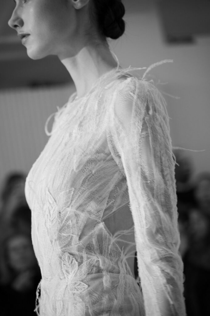 Profile of the sheer embroidered Anouka wedding dress by Mira Zwillinger on the runway