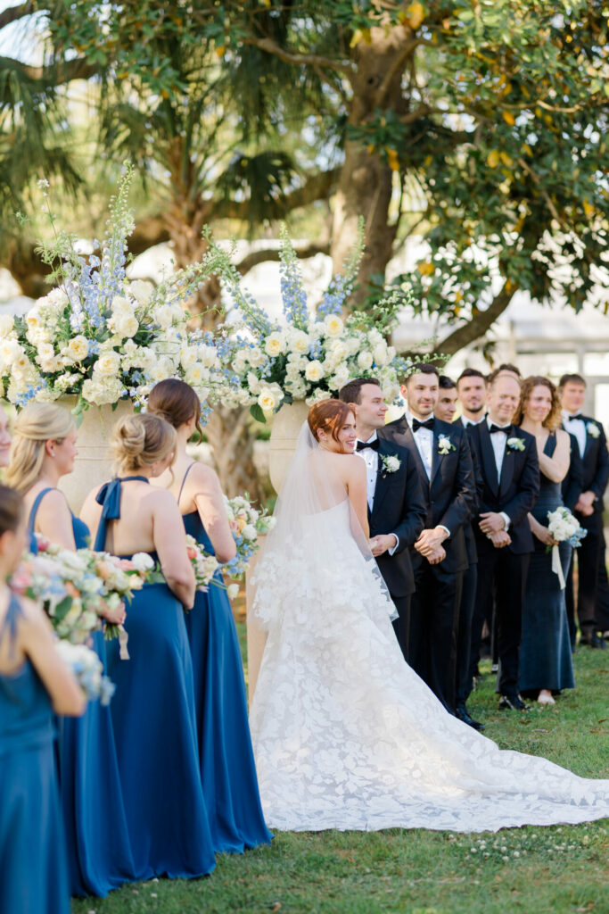 Bride and groom with wedding party outdoors.