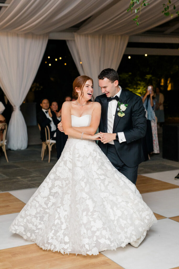 Bride and groom dancing, elegant wedding setting.
