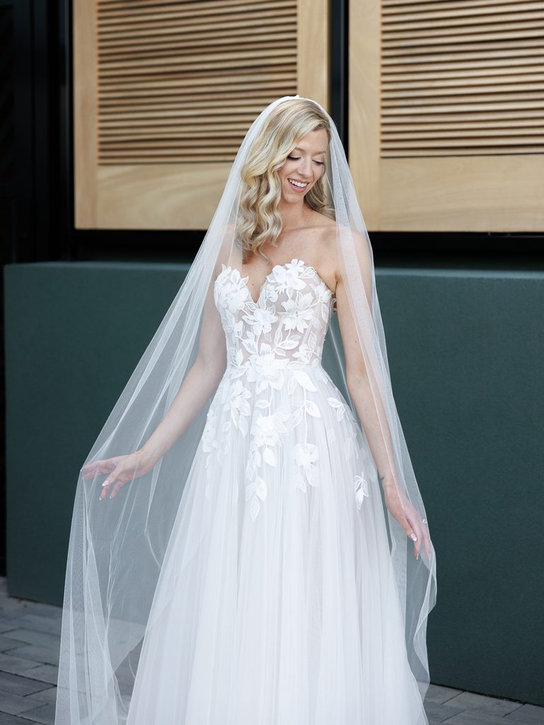 Smiling bride Katya Ruiz in luxury lace dress.