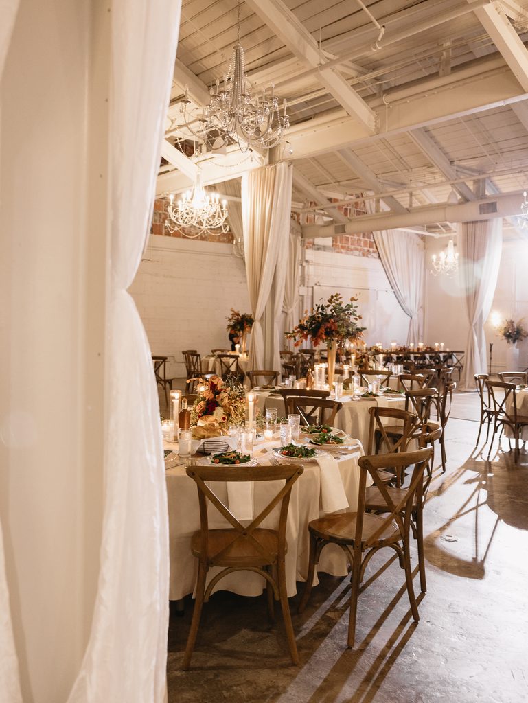 Romantic indoor event with elegant dinner settings.