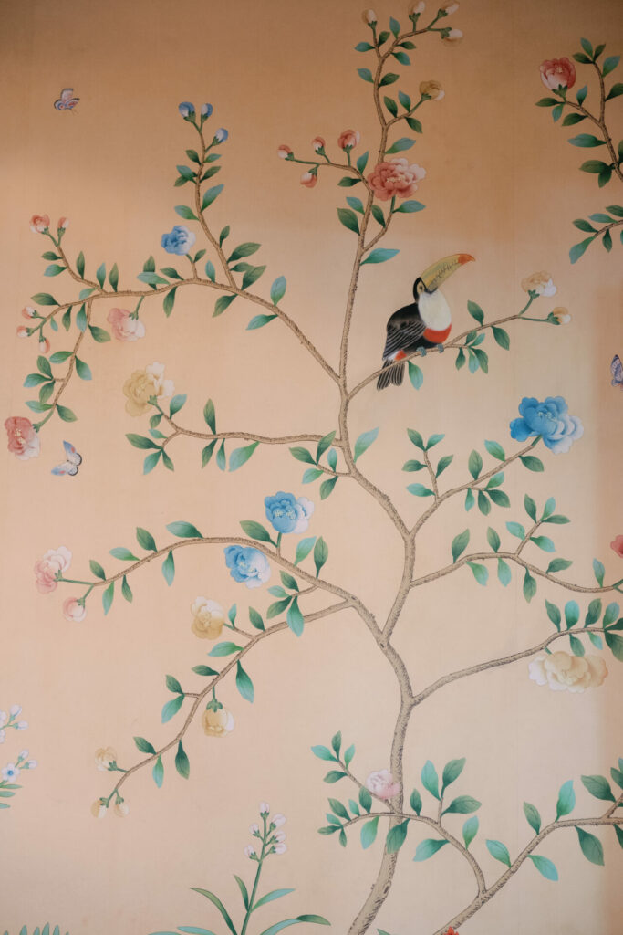 Toucan on blossoming branches, elegant beige mural.