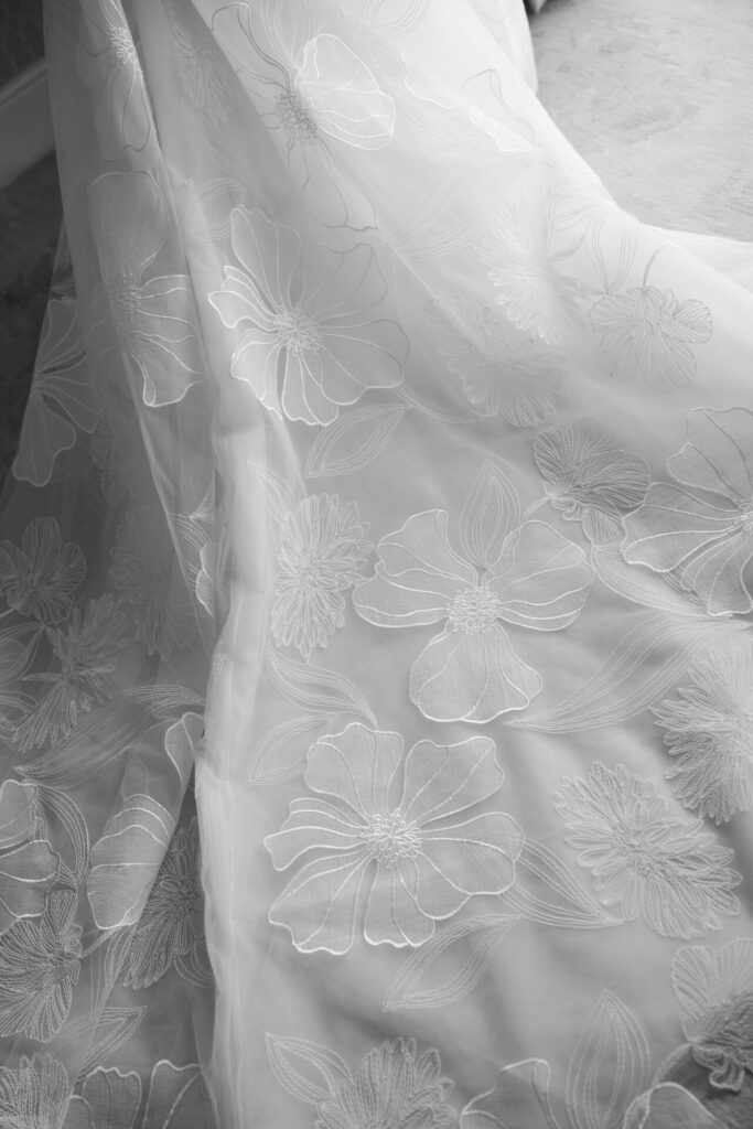 Sheer white fabric with large embroidered florals.