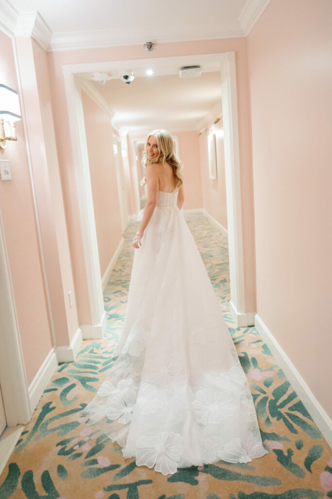 Katya Ruiz in strapless floral gown, smiling back.