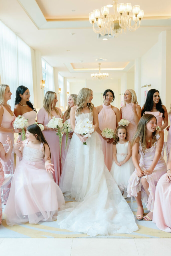 Katya Ruiz with bridesmaids, all in pink, smiling.