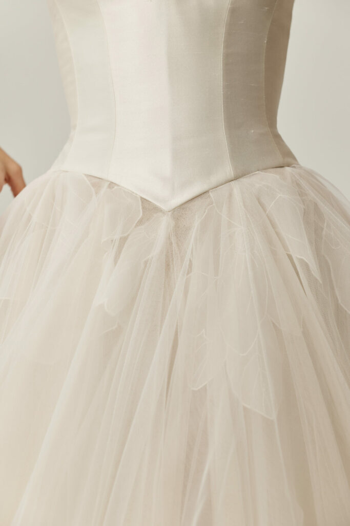 White Clea dress, fitted bodice, petal tulle skirt.