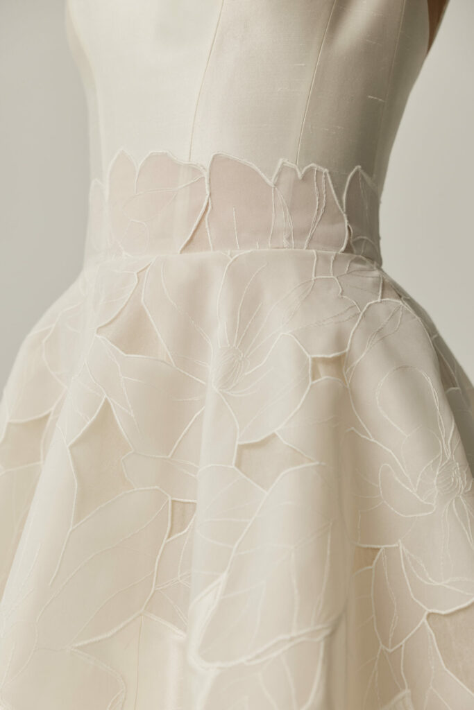 White Clea wedding dress with sheer floral embroidery.