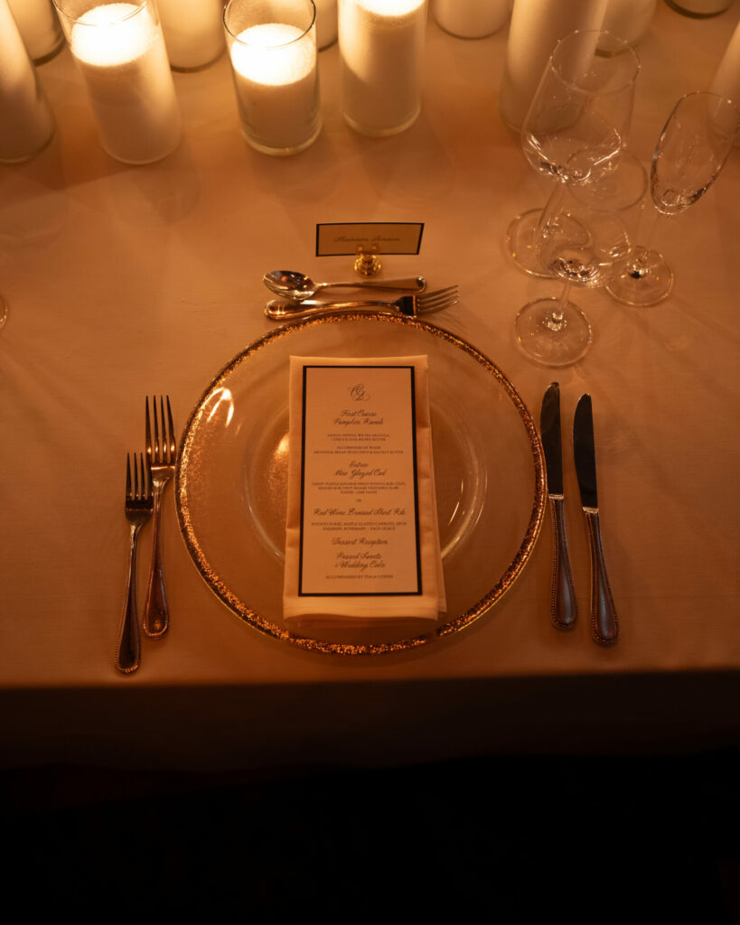 Luxurious table setting with gold accents and candles.