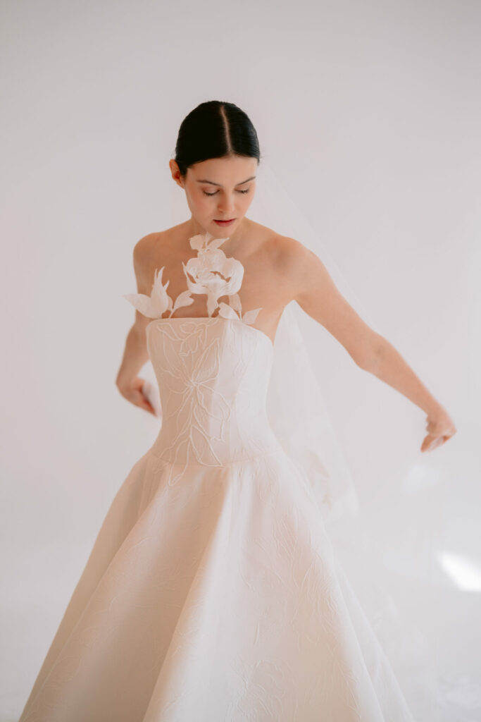 Woman in strapless floral Clea wedding dress.
